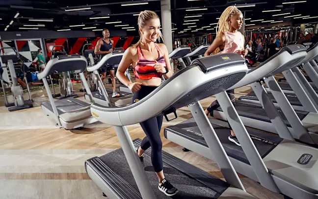 Two women on treadmills at Virgin Active