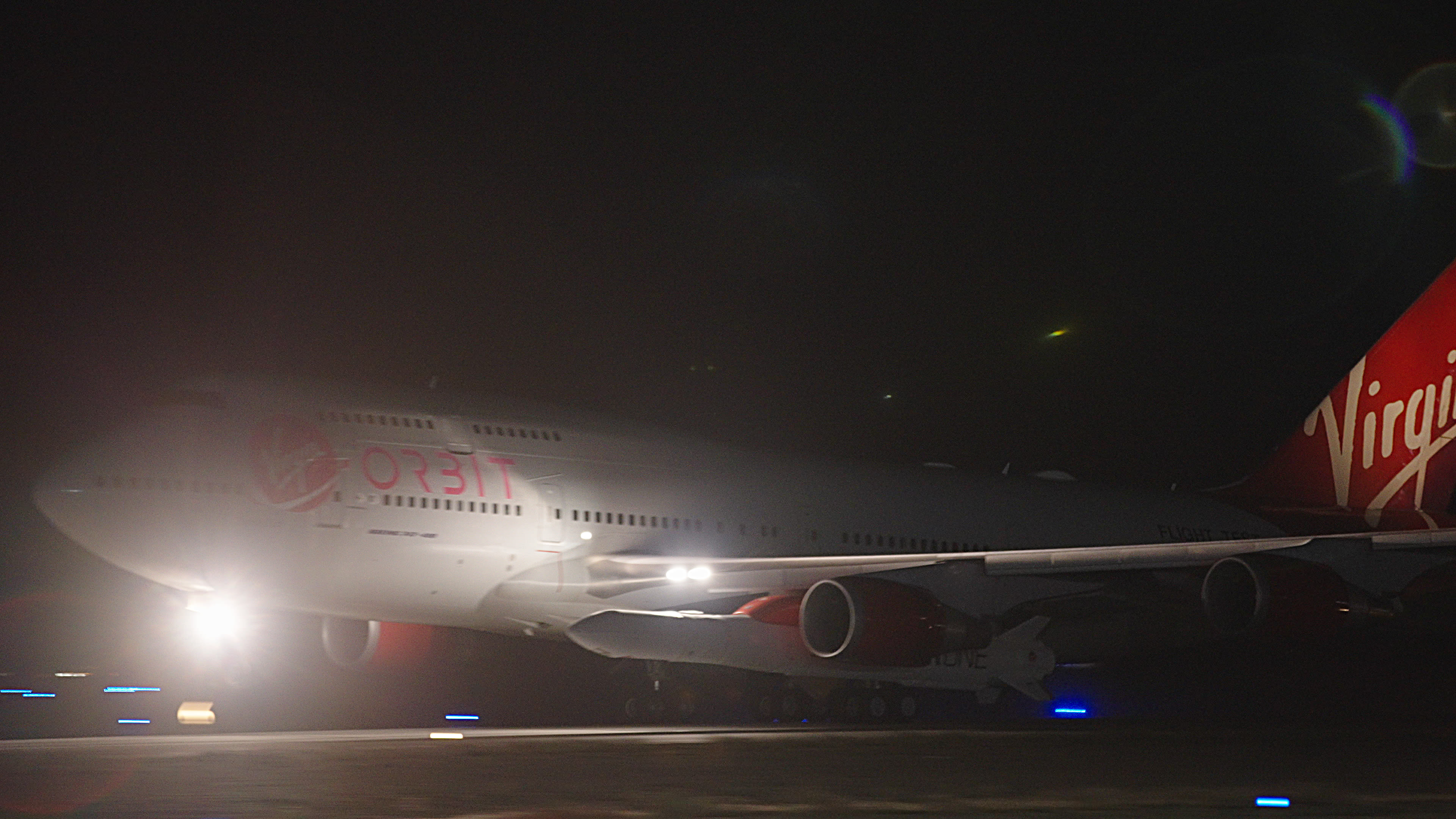 Modified Boeing 747 Cosmic Girl taking off for the Straight Up launch with LauncherOne beneath the wing