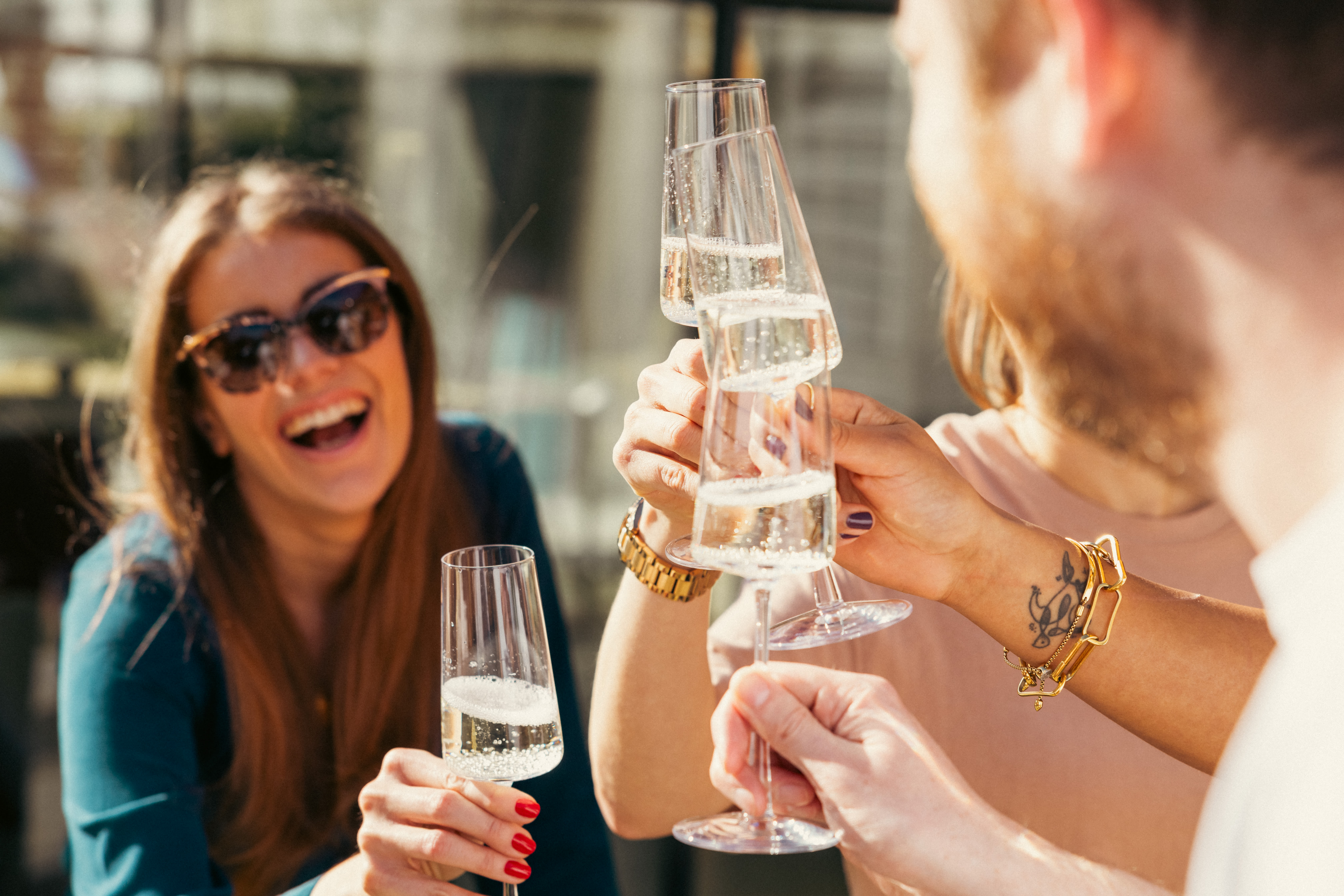 Woman laughing with a glass of wine from Virgin Wines