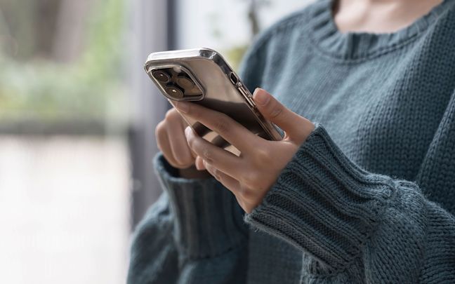 A woman's hands holding a smartphone