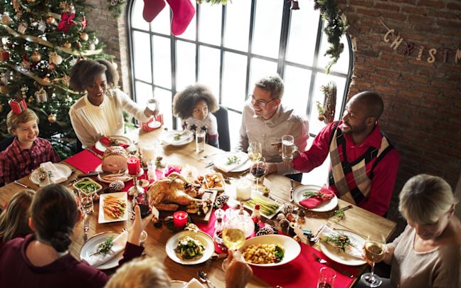 A family gathering round a table for Christmas dinner