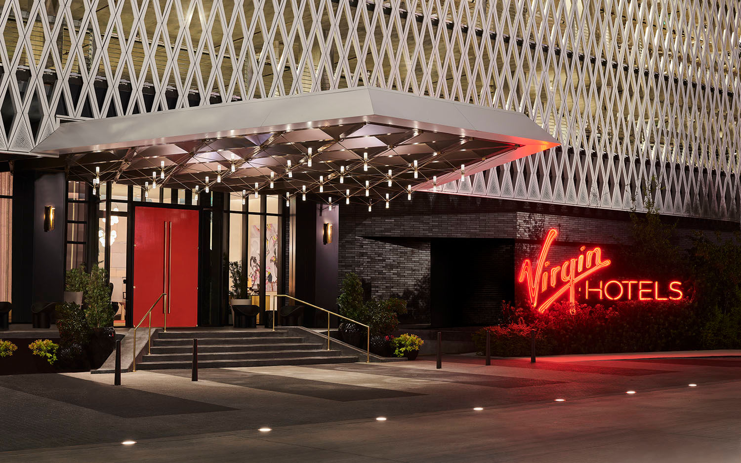 The entrance to Virgin Hotels Dallas, a red neon sign reads Virgin Hotels