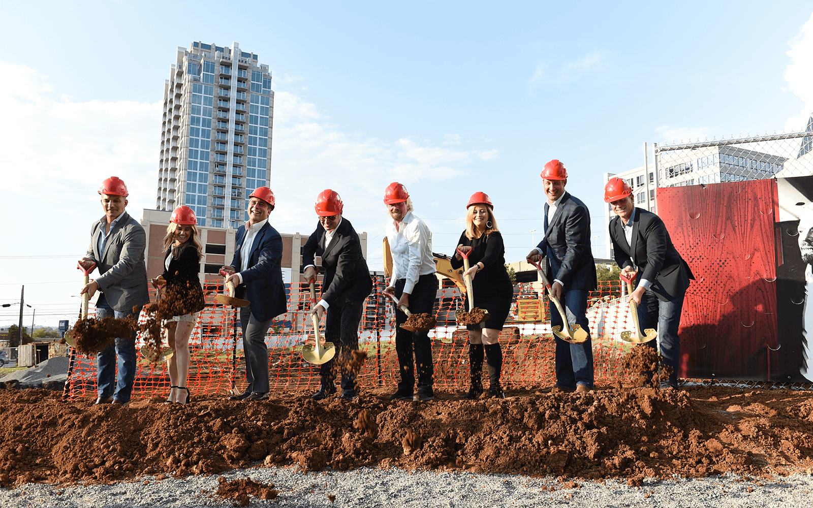 Richard Branson and team with spades and hard hats 